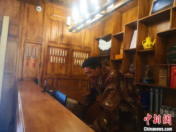 圖為桑杰才讓用電腦處理財務(wù)。　史靜靜 攝
